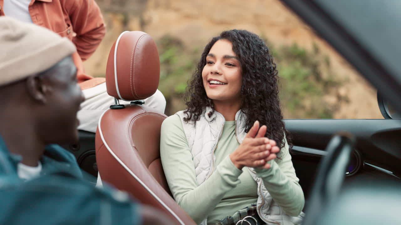 Friends enjoying a road trip in a convertible