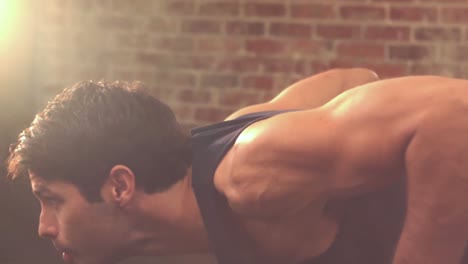 fit man doing push ups in crossfit studio