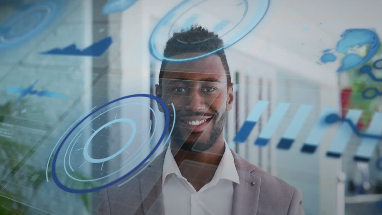 Animation of graphs, globe and loading circles over smiling african american man standing in office