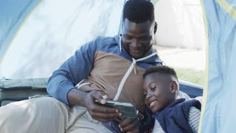 African-American-father-and-son-enjoy-a-moment-in-a-tent-outdoors