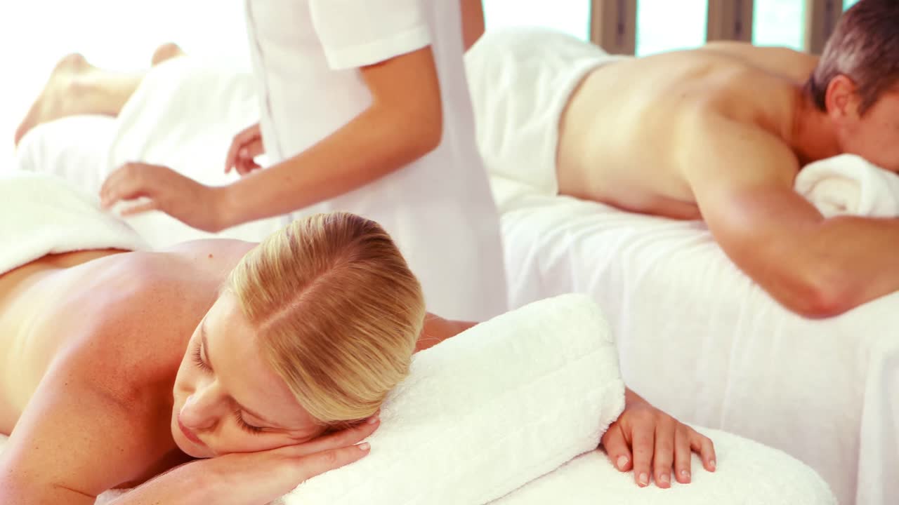 마사지 전문가 가 편안 한 부부 를 마사지 하고 있다