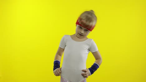 young child in sportswear making fitness gymnast home exercises. workout for kids. sporty girl