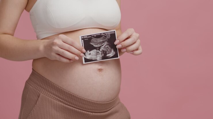 Pregnant Woman Holding Ultrasound Scan