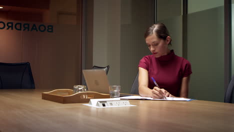 young white businesswoman working late in office, close up shot on r3d