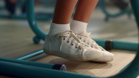 Closeup-girl-moving-legs.-Female-student-feet-under-school-desk-in-classroom