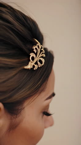 elegant gold ornate hair clip in dark hair