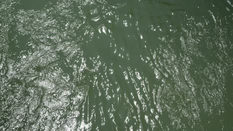 up close macro video of water flowing and the suns reflection off of it.