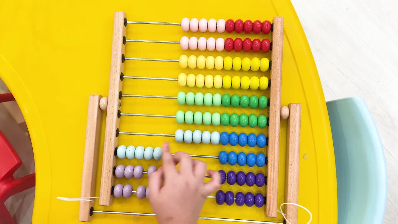 Child learning math with colorful abacus beads