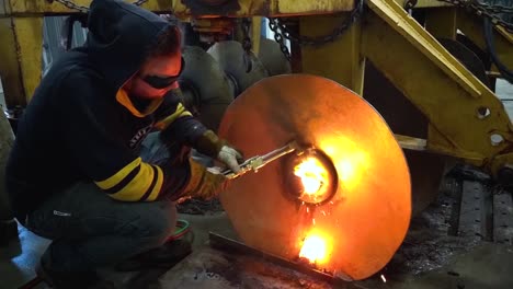 A-man-cut's-a-large-piece-of-steel-with-a-cutting-torch