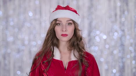 woman in santa claus costume excited and surprised