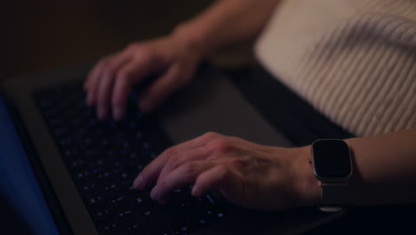 close-up of a woman's face who ponders while working on a laptop is lost in thought she works late at night