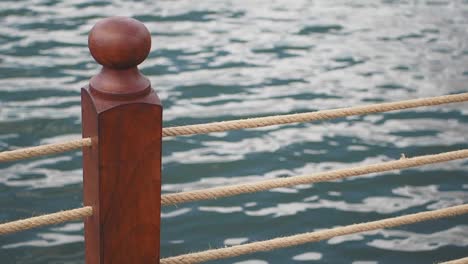 close-up of a wooden post with rope on a dock