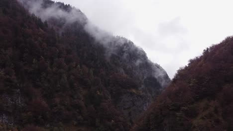 epic cinematic aerial scenery of steep mountain hill in fall