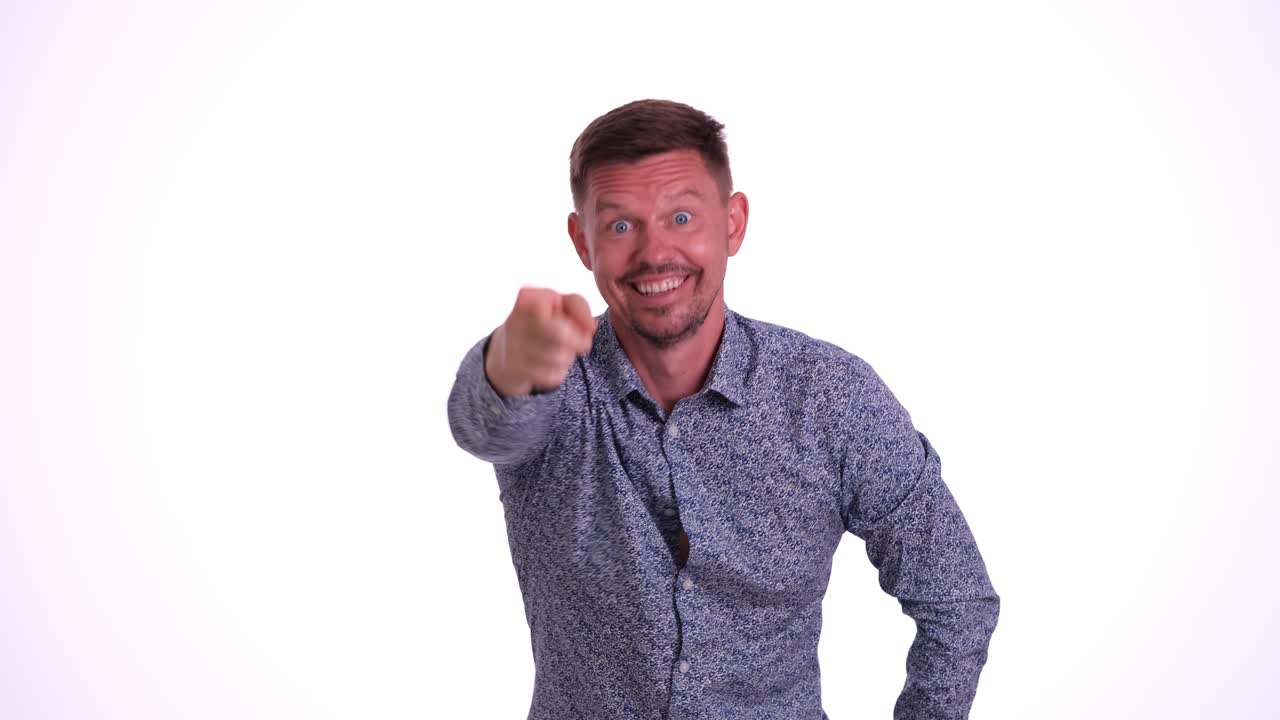 Man in blue shirt smiling on white background