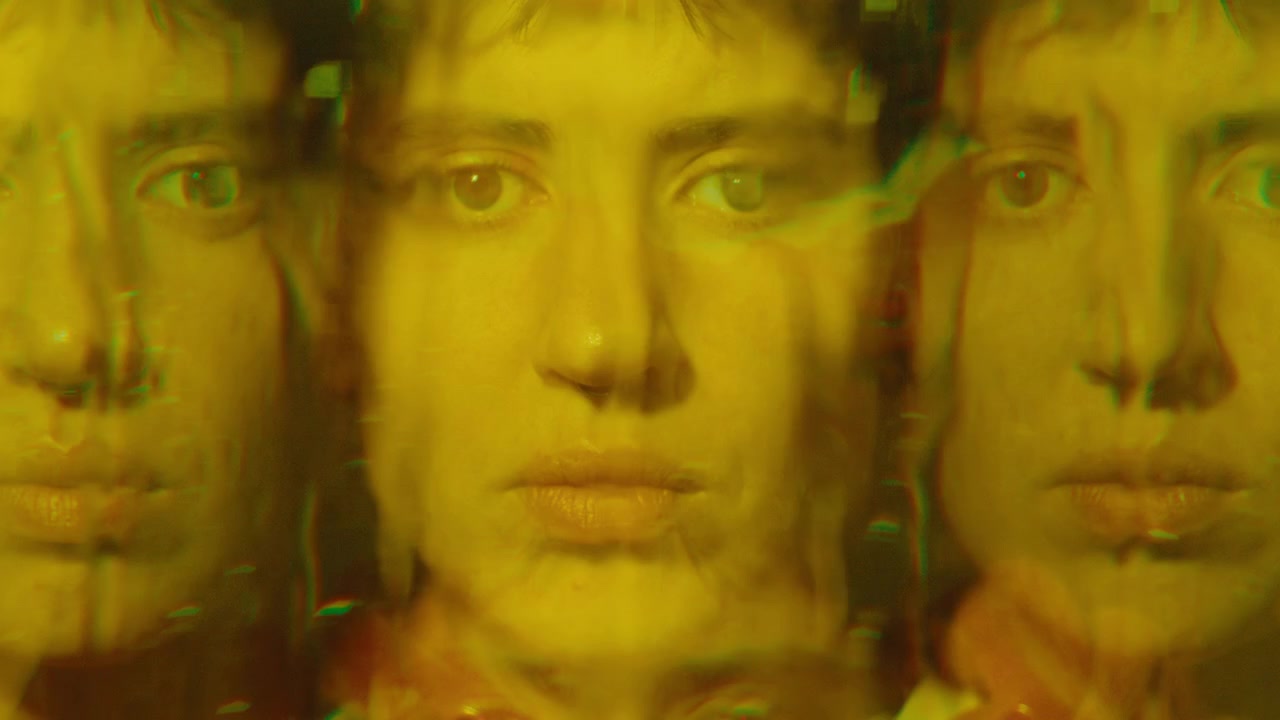Sad Woman Looking at Camera through Wet Window