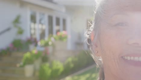 Portrait-of-happy-asian-senior-woman-on-sunny-day-in-garden