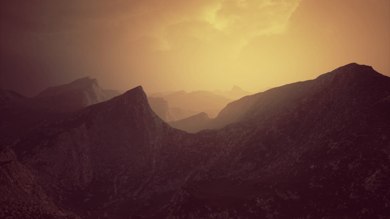 Dramatic sunset casting golden light over rugged mountain landscape