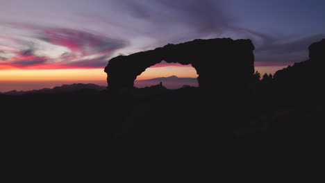 aerial-view-traveling-out-the-Nublo-window-during-the-sunset,-with-beautiful-colors