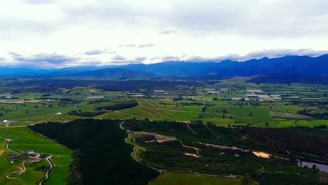 pov helicopter aerial flying over the rolling green hills of the motueka valley near abel tasman, new zealand