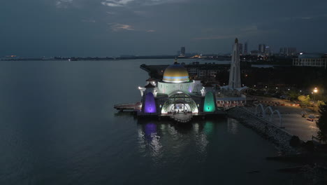 Drone-Circles-Rainbow-Mosque-Masjid-Selat-On-The-Water-In-Early-Evening-Melaka-Malaysia