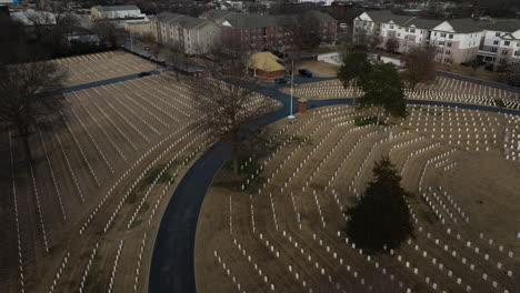 flyover aerial shot of fayetteville national cemetery, many white graves, day