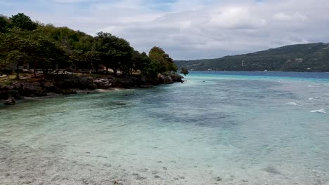 Drone-footage-of-crystal-clear-blue-water-and-waves-on-the-shore-of-beach-in-Cebu-Philippines-8