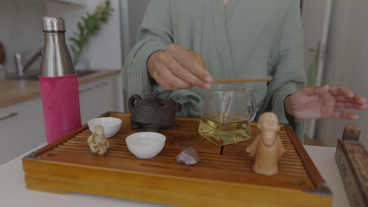 Woman performing tea ceremony with incense