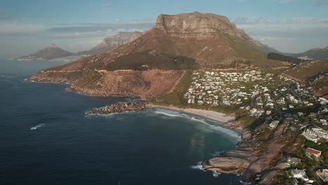 Cape-Town,-South-Africa---Llandudno's-Coastal-Neighborhood-with-Judas-Peak-Towering-in-the-Background---Aerial-Drone-Shot