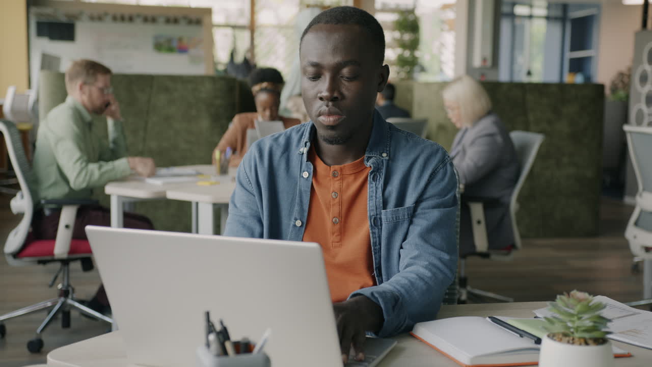 Man Working on Laptop in Modern Office