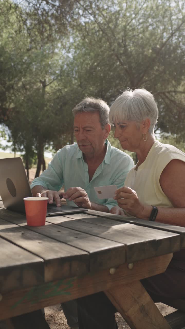 Senior Couple Shopping Online Outdoors