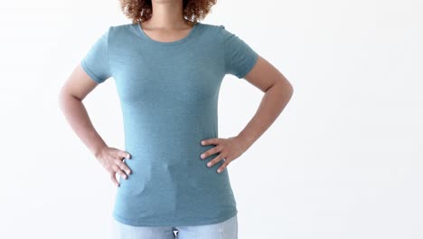 Midsection-of-african-american-woman-wearing-blue-t-shirt-with-copy-space-on-white-background