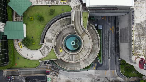 Aerial-view-rising-above-a-parking-ramp-at-the-Plaza-inn-office-complex,-in-Mexico-city,-America---top-down,-drone-shot