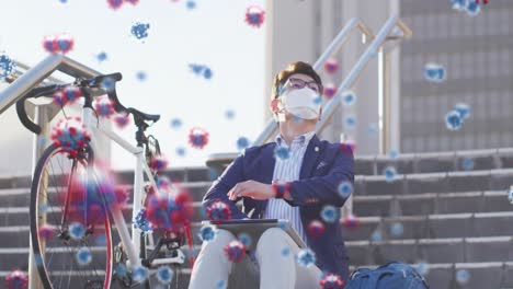 animation of virus cells over asian businessman with face mask