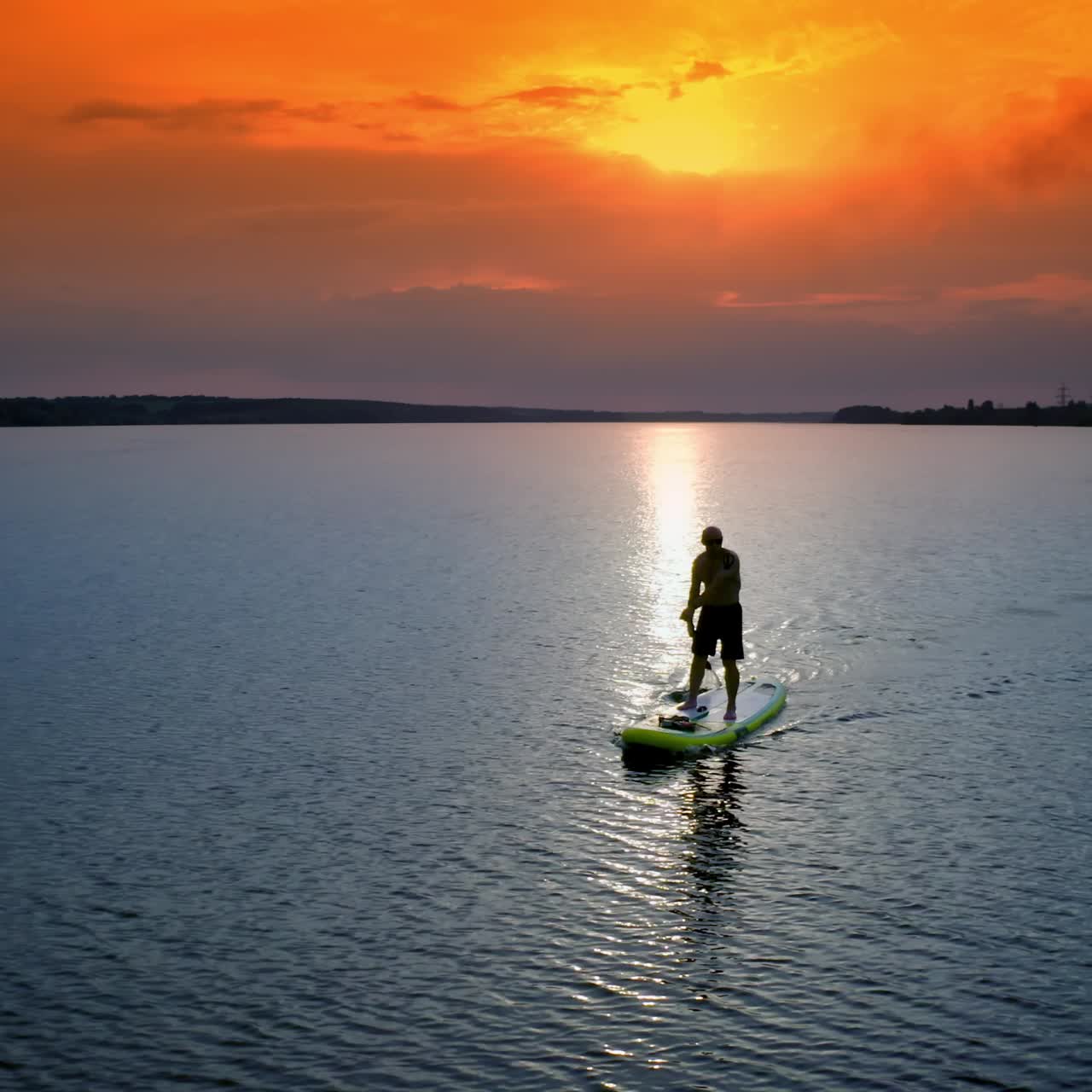 Athletic man standing with paddle. Surfer floating sup board on vacation