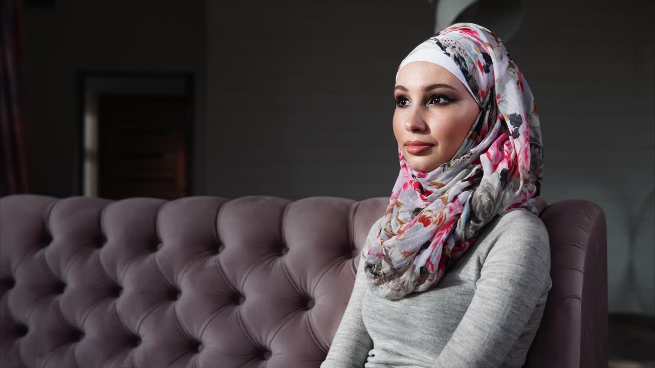Woman in Hijab Sitting on a Sofa