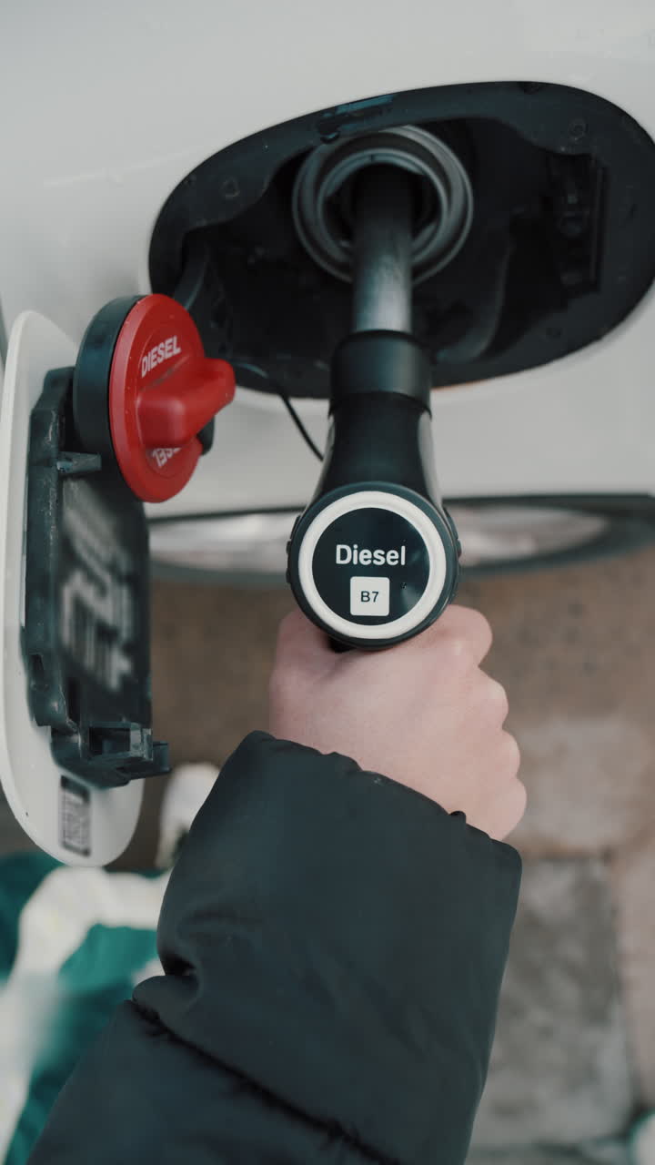 Refueling a car with diesel at a gas pump station with overcharges