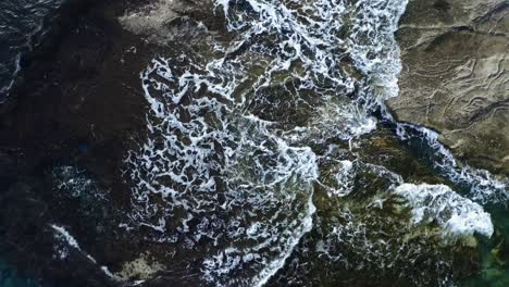 Aerial-drone-footage-of-sea-waves-hitting-the-rocks