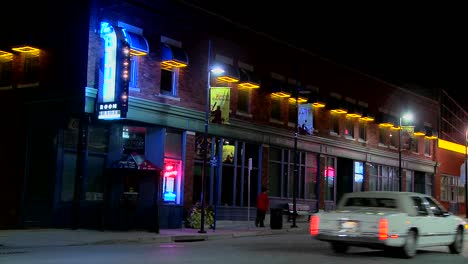 Exterior-of-pub-or-bar-at-night-with-motorcycles-passing