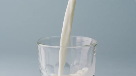 Video-of-glass-of-milk-with-copy-space-on-blue-background