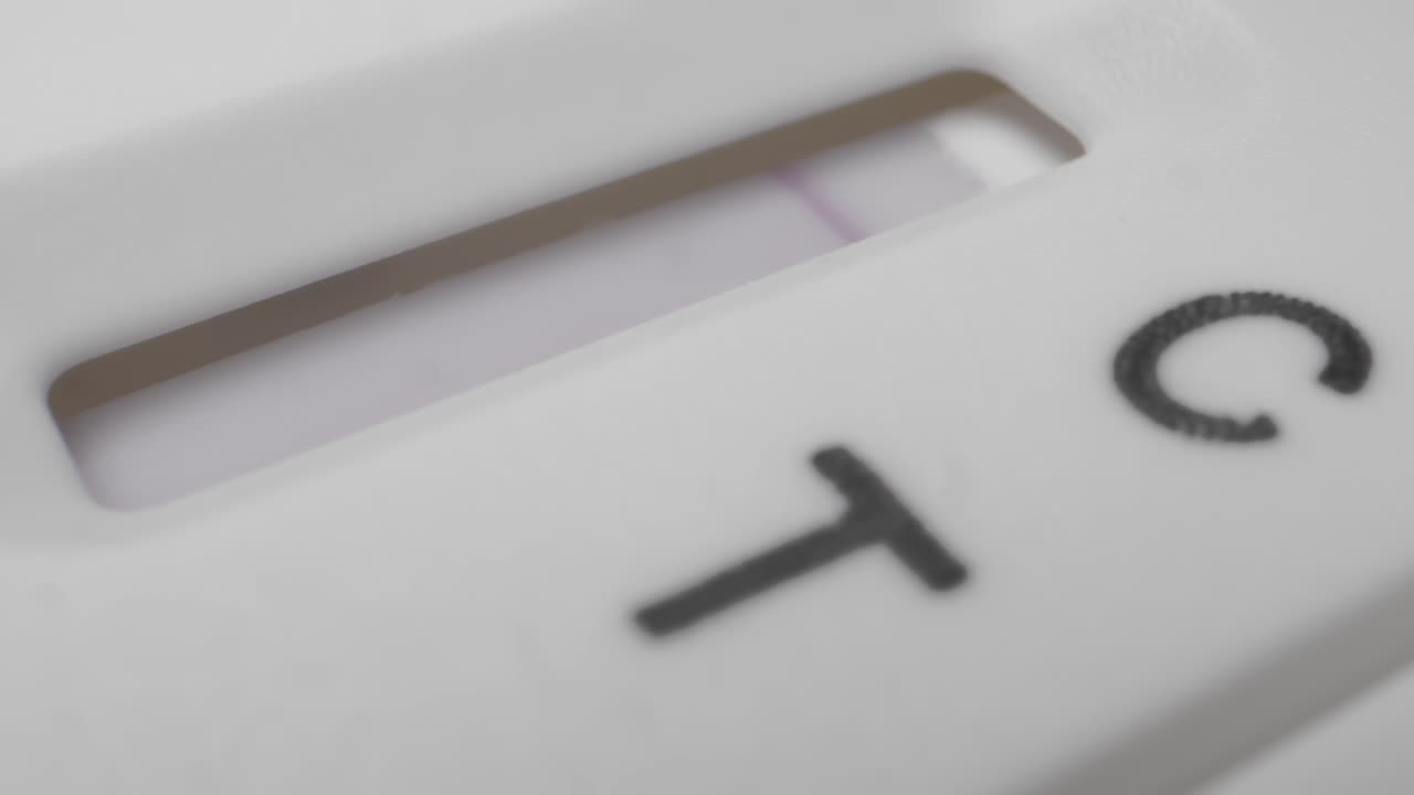 Extreme close-up of rapid antigen test for COVID-19, positive result