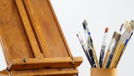 easel and paintbrush on table