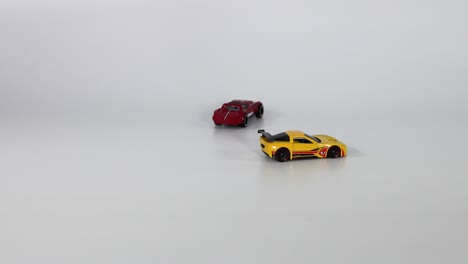 two toy cars meet and collide on track