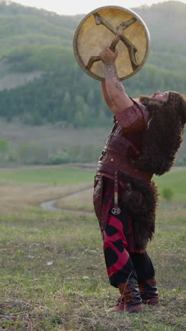 folk rock band dances with tambourines in green valley against old mountains slow motion. siberian religious traditions in modern life