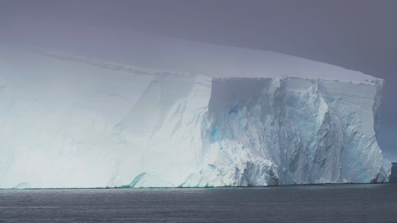 Antarctica Scenery, Massive Iceberg in Cold Ocean Water on Foggy Day, Close Up