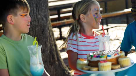 kids having sweet food and drinks in the playground 4k