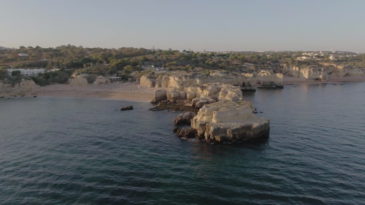Aerial View Orbiting Beach Coastline during Sunset in Algarve, Portugal