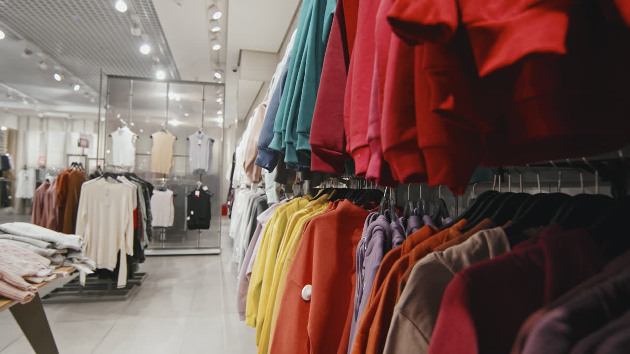 Bright Color Clothes Hanging On Racks In Store
