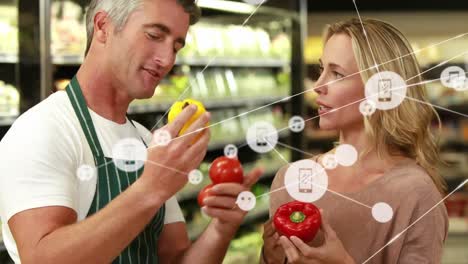 Animation-of-connected-icons,-caucasian-man-discussing-about-bell-peppers-with-woman