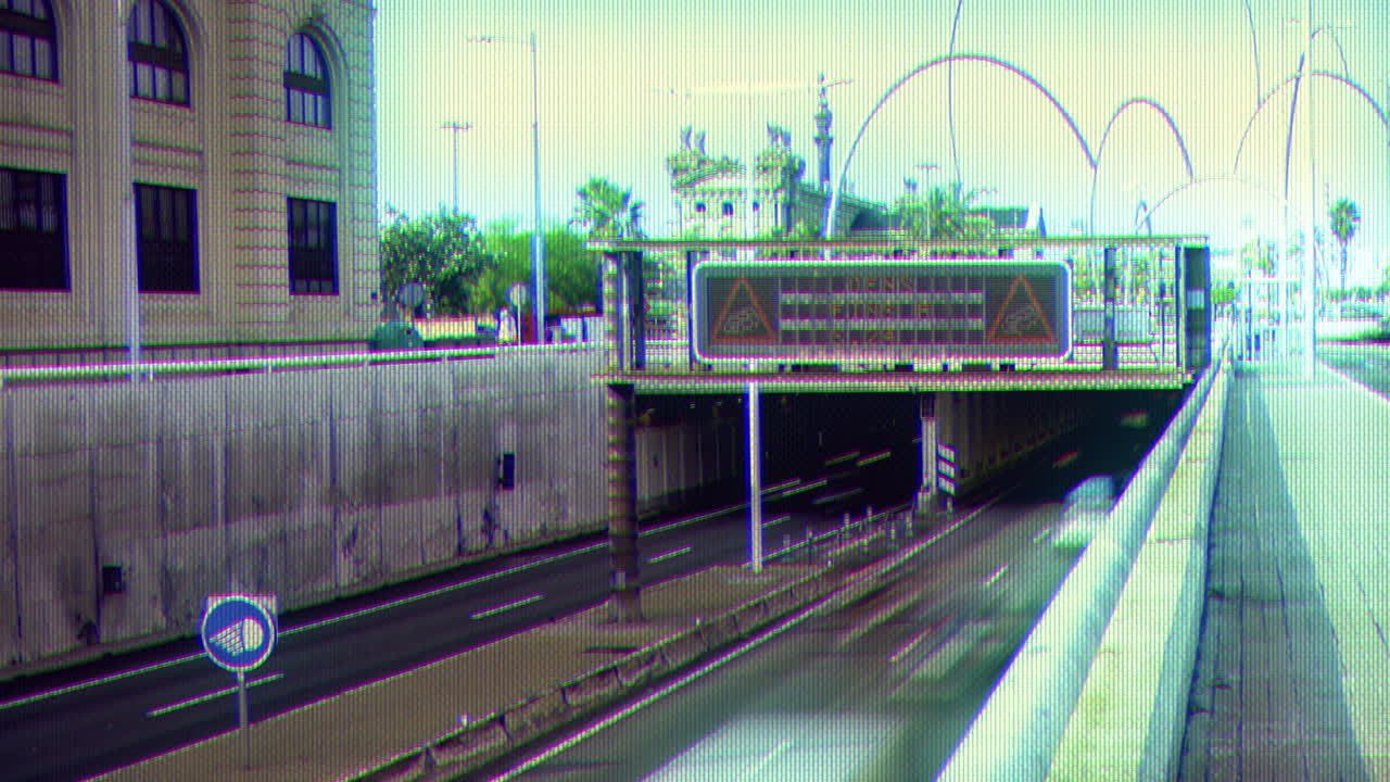 traffic on a highway in barcelona during evening rush hour with vintage CCTV overlay surveillance