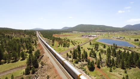 Aerial-very-long-train-heads-west-disappearing-into-the-landscape-near-Williams-Arizona